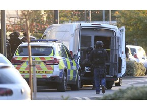 Police at the scene at Bermuda Park in Nuneaton, central England, where they are dealing with an ongoing incident, Sunday Oct. 22, 2017. A police department in central England says a reported hostage-taking incident at a bowling alley is "unconnected to any terrorist activity." (Aaron Chown/PA via AP) ORG XMIT: LON843

UNITED KINGDOM OUT  NO SALES  NO ARCHIVE  PHOTOGRAPH CANNOT BE STORED OR USED FOR MORE THAN 14 DAYS AFTER THE DAY OF TRANSMISSION
Aaron Chown, AP