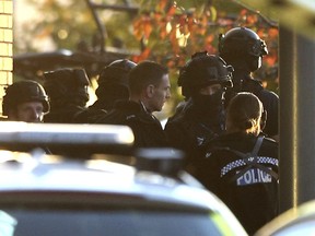 Police at the scene at Bermuda Park in Nuneaton, central England, where they are dealing with an ongoing incident, Sunday Oct. 22, 2017. A police department in central England says a reported hostage-taking incident at a bowling alley is "unconnected to any terrorist activity." (Aaron Chown/PA via AP)