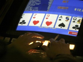 FILE - In this Feb. 17, 2005 file photo, an unidentified man plays video poker at the Carson Station in Carson City, Nev. Authorities trying to piece together the final days before Stephen Paddock unleashed his arsenal of powerful firearms on a crowd of country music fans Sunday, Oct. 1, 2017, have at least one potential trove of information: his gambling habits. Nevada gambling regulators say they're sorting through documents for clues about him and his girlfriend, Marilou Danley. (AP Photo/Cathleen Allison, File)