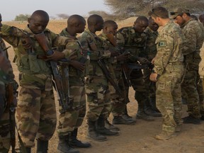 Members of Canadian Special Operations Forces Command inspect weapons prior to entering a range during Flintlock 2017 in Diffa, Niger, February 25, 2017. Niger is one of seven African nations to host Flintlock 2017. (U.S. Army photo by Spc. Zayid Ballesteros)