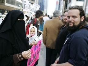 Zaynab Khadr, left, and her former husband Joshua Boyle protest in front of the Metro Convention centre in Toronto on Friday May 29, 2009.