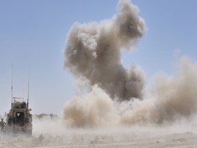 Canadian Combat Engineers neutralize an improvised explosive device in Afghanistan. DND photo.