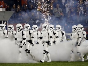 Stormtroopers march down the field during the halftime of an NFL football game between the Chicago Bears and the Minnesota Vikings, Monday, Oct. 9, 2017, in Chicago. The trailer for "Star Wars: The Last Jedi" debuted in dramatic fashion during Monday Night Football halftime. Fireworks flashed and Stormtroopers marched onto Chicago's Soldier Field as the preview played onscreen. (AP Photo/Charles Rex Arbogast)