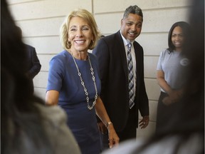 Accompanied by principal Anthony Cherry, U.S. Secretary of Education Betsy Devos is greeted by 21st Century Charter School students, Friday, Sept. 15, 2017, in Gary, Ind. (John J. Watkins/The Times via AP) ORG XMIT: INHAM802

MANDATORY CREDIT; CHICAGO LOCALS OUT; GARY OUT
John J. Watkins, AP