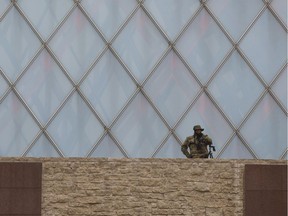 A sniper stands guard as people gather for a vigil to stand together in solidarity against violence after a terrorist incident in Edmonton, Alta., on Sunday, October 1, 2017. THE CANADIAN PRESS/Jason Franson ORG XMIT: EDM114
Jason Franson,