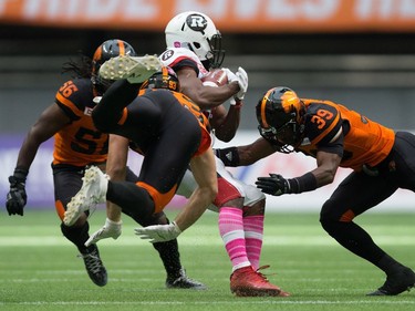 Craig Roh, William Powell, Chandler Fenner

B.C. Lions' Craig Roh, front left, and Chandler Fenner, right, tackle Ottawa Redblacks' William Powell during the first half of a CFL football game in Vancouver, B.C., on Saturday, October 7, 2017. THE CANADIAN PRESS/Darryl Dyck ORG XMIT: VCRD120
DARRYL DYCK,