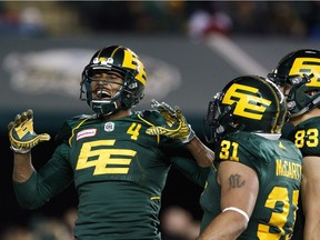 Eskimos receiver Adarius Bowman (4) celebrates his touchdown against the Stampeders with Calvin McCarty (31) and Brandon Zylstra (83) in the second half of Saturday's game. THE CANADIAN PRESS/Amber Bracken