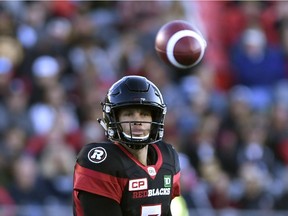 Redblacks quarterback Trevor Harris follows the flight of a pass after he throws the ball during the Sept. 9 game against the Tiger-Cats. Harris was injured in the second half of that game and hasn't played in a contest since, but is expected to start Saturday in Vancouver against the Lions. THE CANADIAN PRESS/Justin Tang