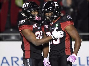 Ottawa Redblacks running back William Powell (29) celebrates his touchdown with teammate wide receiver Diontae Spencer (85) during second half CFL action against the Hamilton Tiger-Cats in Ottawa on Friday, Oct. 27, 2017.