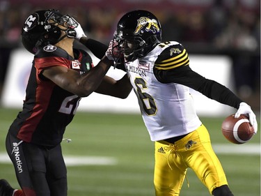 Tiger-Cats wide receiver Brandon Banks (16) fends off Redblacks defensive back Corey Tindal (28). THE CANADIAN PRESS/Justin Tang