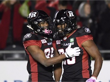 Redblacks running back William Powell (29) celebrates his fourth-quarter touchdown with wide receiver Diontae Spencer (85). THE CANADIAN PRESS/Justin Tang