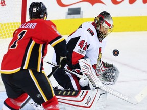 Senators netminder Craig Anderson makes a save in front of Flames forward Mikael Backlund in the first period of Friday's game at Calgary. Al Charest/Postmedia