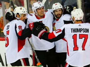 Senators defenceman Cody Ceci, far left, celebrates with teammates after scoring against the Flames late in the first period of Friday's game. Al Charest/Postmedia