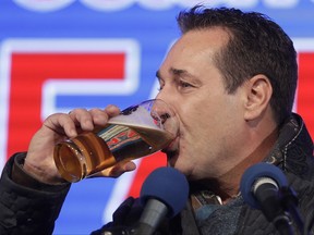 Hans-Christian Strache, leader of the strongly eurosceptic Austrian Freedom Party FPOE, drinks a beer during the final campaign rally of his party in Vienna, Austria, Friday, Oct. 13, 2017. Austria will hold national elections on Sunday, Oct. 15, 2017. (AP Photo/Matthias Schrader)