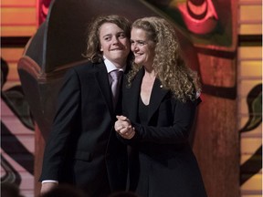Laurier Payette Flynn hugs his mother, Governor General Julie Payette, during a reception at the Canadian Museum of History in Gatineau on Monday.