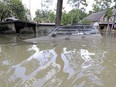 FILE - In this Sept. 4, 2017, file photo, a car is submerged in floodwater in the aftermath of Hurricane Harvey near the Addicks and Barker Reservoirs in Houston. Many homeowners in several suburban Houston subdivisions who were flooded during Harvey's torrential rainfall are questioning if local officials did enough to warn them a nearby reservoir could overflow during a heavy storm event and inundate their homes.