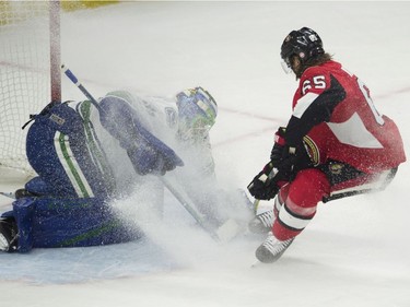 Vancouver Canucks goalie Anders Nilsson makes a save on Ottawa Senators defenceman Erik Karlsson during first period NHL action Tuesday, October 17, 2017 in Ottawa.