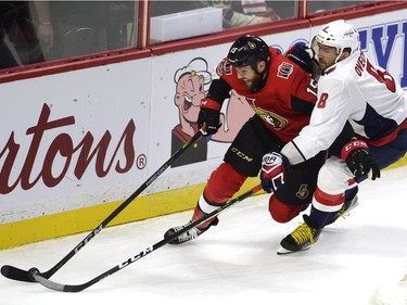 Ottawa Senators left wing Zack Smith (15) and Washington Capitals left wing Alex Ovechkin (8) battle for the puck during second period NHL hockey action in Ottawa on Thursday, October 5, 2017. THE CANADIAN PRESS/Adrian Wyld ORG XMIT: JFJ509
Adrian Wyld,