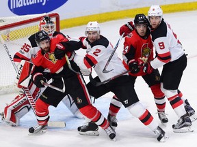 The Ottawa Senators' Tom Pyatt (10) and Jean-Gabriel Pageau (44) battle for position with John Moore (2) and Taylor Hall (9) in front of New Jersey Devils goaltender Cory Schneider on Thursday, Oct 19, 2017 at the Canadian Tire Centre.