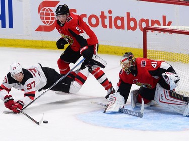 New Jersey Devils centre Pavel Zacha attempts a shot on Ottawa Senators goalie Craig Anderson as Bobby Ryan defends in the third period.