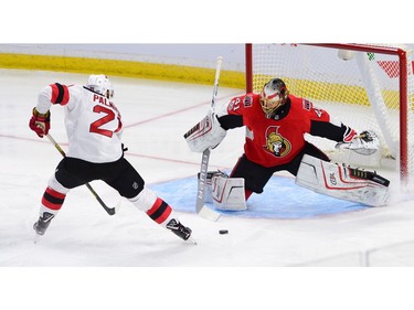 Ottawa Senators goalie Craig Anderson makes a save against the New Jersey Devils' Kyle Palmieri.