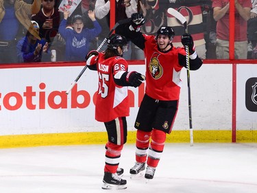 The Ottawa Senators' Alexandre Burrows, right, celebrates a goal with teammate Erik Karlsson.