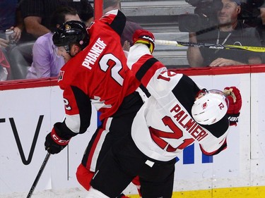 Ottawa Senators defenceman Dion Phaneuf collides with the New Jersey Devils' Kyle Palmieri.