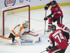 Senators winger Tom Pyatt, top, watches as a pass from Mark Borowiecki hits a defender's stick and enters the net behind Flyers goaltender Michal Neuvirth for a goal in last Thursday's game at Canadian Tire Centre. THE CANADIAN PRESS/Adrian Wyld