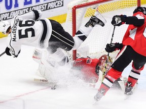 Senators goalie Mike Condon makes a save on the Kings' Kurtis MacDermid as Senators' Mark Stone looks on during the second period on Tuesday night. THE CANADIAN PRESS/Sean Kilpatrick