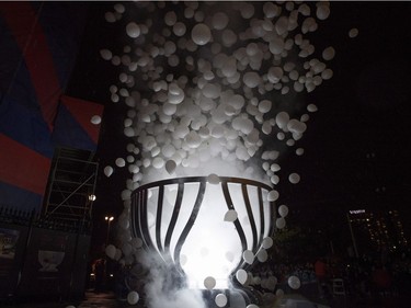 Balloons and smoke drift skyward as Lord Stanley's Gift Monument is unveiled on Sparks Street on Saturday. THE CANADIAN PRESS/Justin Tang