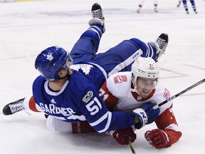 Toronto Maple Leafs defenceman Jake Gardiner (51) falls over Detroit Red Wings centre Dylan Larkin (71) during third period NHL hockey action in Toronto on Wednesday, October 18, 2017. THE CANADIAN PRESS/Nathan Denette ORG XMIT: NSD523
Nathan Denette,