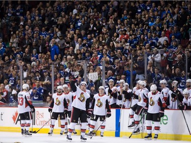 Ottawa Senators' Alex Burrows, front left, acknowledges a standing ovation from the crowd after a video tribute was played for him by his former team, the Vancouver Canucks, during first period NHL hockey action in Vancouver on Tuesday, October 10, 2017.