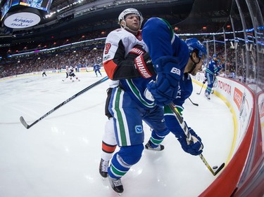 Ottawa Senators' Bobby Ryan, left, checks Vancouver Canucks' Michael Del Zotto during first period NHL hockey action in Vancouver on Tuesday, October 10, 2017.