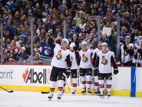 Ottawa Senators' Alex Burrows, front, acknowledges a standing ovation from the crowd after a video tribute was played for him by his former team, the Vancouver Canucks, during first period NHL hockey action in Vancouver on Tuesday, October 10, 2017.