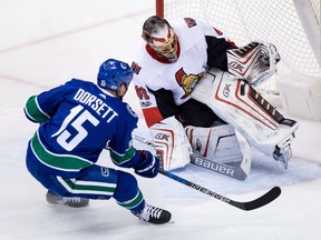 Ottawa Senators goalie Craig Anderson, right, stops Vancouver Canucks' Derek Dorsett during second period NHL hockey action in Vancouver on Tuesday, October 10, 2017.