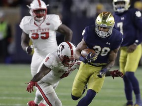 Notre Dame's Deon McIntosh (38) is tackled by North Carolina State's Jerod Fernandez (4) during the second half of an NCAA college football game, Saturday, Oct. 28, 2017, in South Bend, Ind. Notre Dame won 35-14. (AP Photo/Darron Cummings)