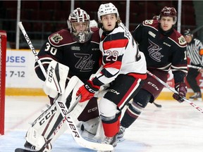 Tye Felhaber of the 67's gets tangled with Petes goalie during the OHL game at TD Place arena on Friday night. Felhaber would eventually score the winning goal in the shootout. Jean Levac/Postmedia