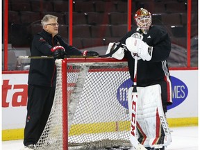 Associate coach Marc Crawford chats with goalie Mike Condon during Senators practice at Canadian Tire Centre on Monday. Jean Levac/Postmedia