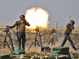 Iraqi forces fire mortars against Kurdish Peshmerga positions near Faysh Khabur, on the Turkish and Syrian border.