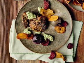 Garlic-seasoned lamb chops are served with mint chutney, chips made of carrots, turnips and beets, and cipollini onions braised in chicken stock.
