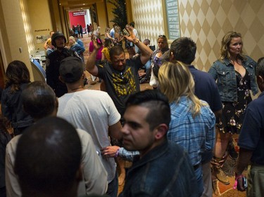 People are searched by Las Vegas police at the Tropicana Las Vegas during an active shooter situation on the Las Vegas Strip on Sunday, Oct. 1, 2017. Multiple victims were being transported to hospitals after a shooting late Sunday at a music festival on the Las Vegas Strip.