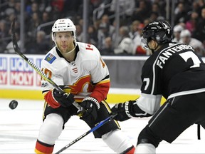 Calgary Flames right wing Kris Versteeg, left, passes the puck as Los Angeles Kings defenseman Oscar Fantenberg, of Sweden, defends during the first period of an NHL hockey game, Wednesday, Oct. 11, 2017, in Los Angeles. (AP Photo/Mark J. Terrill)