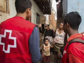 Red Cross volunteers talk to villagers about the plague outbreak, 30 miles west of Antananarivo, Madagascar.