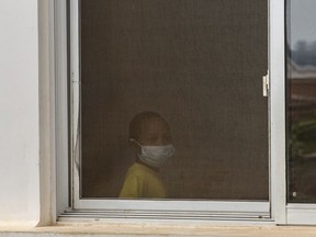 In this photo taken Tuesday Oct. 10, 2017, a child wears a face mask inside a hospital in the capital Antananarivo, Madagascar. A plague outbreak has brought panic to the city dwellers with schools closed and public gatherings banned as the death toll still mounts in the Indian Ocean island nation.  (AP Photo/Alexander Joe) ORG XMIT: XDF103

PHOTO TAKEN OCT. 10, 2017
Alexander Joe, AP