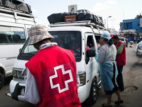 Doctors and nurses from The Ministry of Health and officers of the Malagasy Red Cross staff a healthcare checkpoint at the "taxi-brousse" station of Ampasapito district in Antananarivo on October 5, 2017, with the mission of informing passengers leaving Antananarivo, and to potentially detect cases suspected of plague.