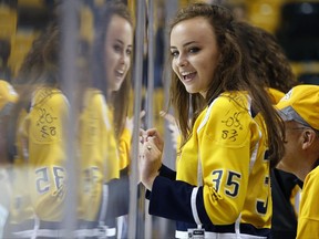 Nashville Predators fan Lauren Zoladz, of Nashville, Tenn. watches warm-ups for an NHL hockey game between the Predators and the Boston Bruins in Boston, Thursday, Oct. 5, 2017. (AP Photo/Michael Dwyer)