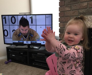 Mike McEwen’s daughter cheers on her father while watching him on television.