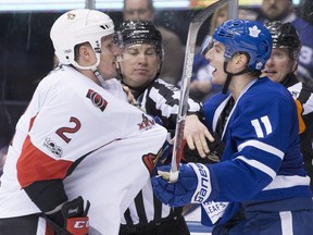 The Senators' Dion Phaneuf tussles with the Maple Leafs' Zach Hyman during a game at Toronto on Jan. 21. THE CANADIAN PRESS/Chris Young