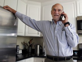 Michael Rosbash takes a call at his home, Monday, Oct. 2, 2017, in Newton, Mass.