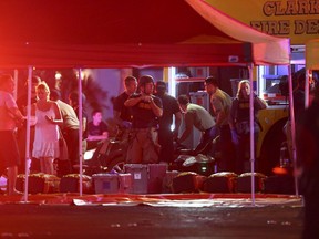 Medics treat the wounded as Las Vegas police respond during an active shooter situation on the Las Vegas Strip on Sunday.